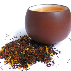 A mix black and flower tea leaves with cup of tea