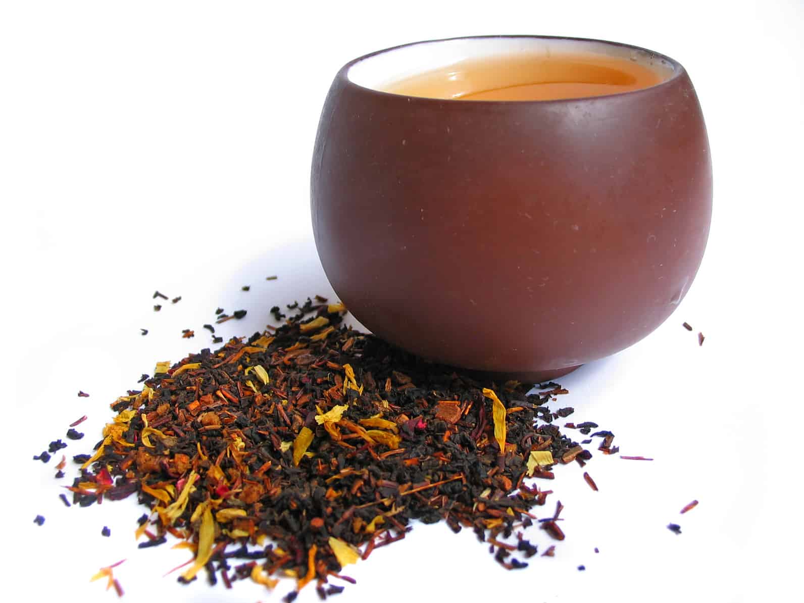 A mix black and flower tea leaves with cup of tea
