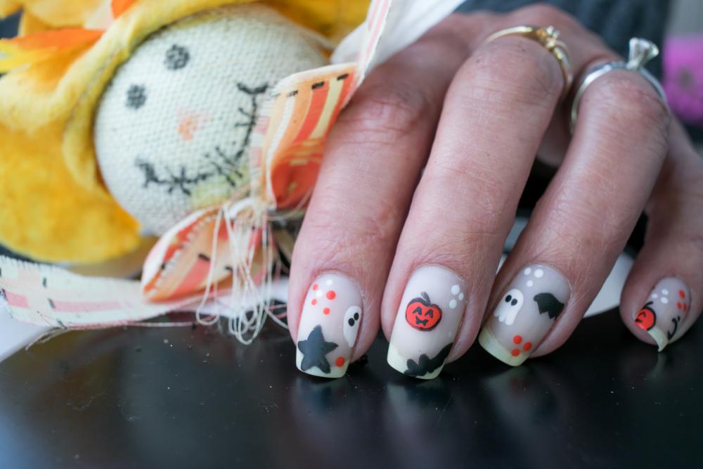 Ghosts, bats, and pumpkins halloween acrylic nails  