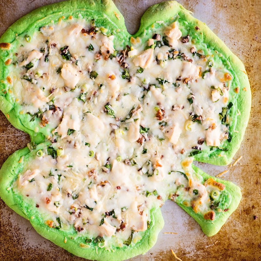 Green shamrock alfredo pizza slices