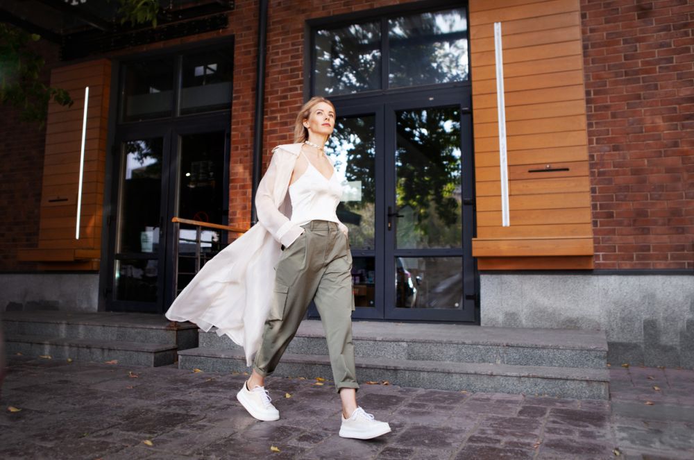 Pastel colored trenchcoat with cargo pants and sneakers
